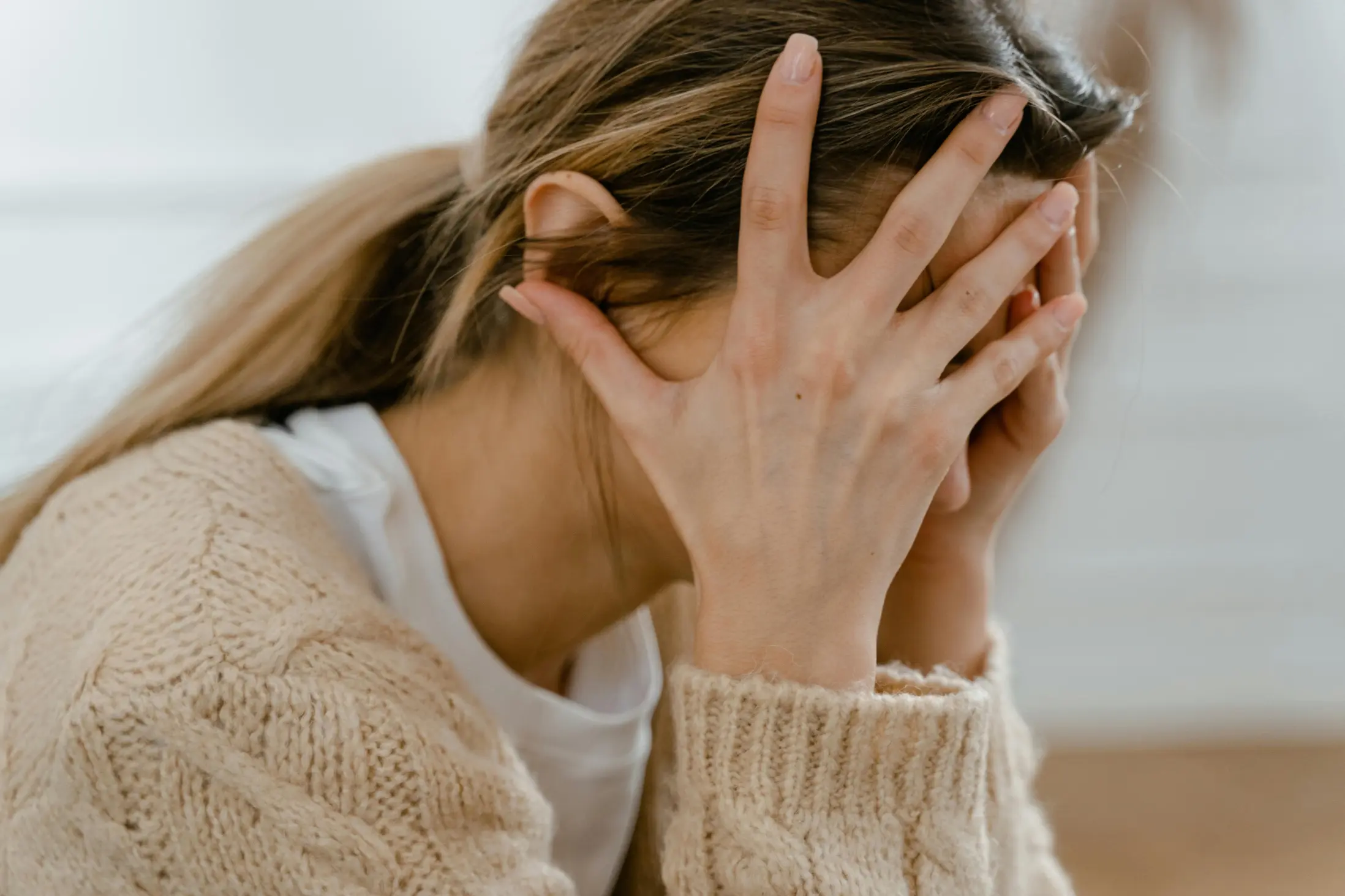 woman holding her head in frustration